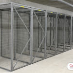 A set of wire mesh storage lockers being used as bicycle lockers. These 7' tall bike lockers allow the user to fully walk into the locker while parking their bike.