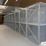 A bank of equipment storage lockers. Each locker has a sturdy shelf and a single door.
