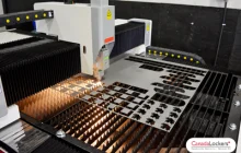 A 3kw fiber laser cutter working to cut storage locker parts out from a sheet of steel.